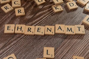 pexels photo 20021295 Scrabble tiles spelling 'Ehrenamt' on a wooden background. Perfect for volunteerism themes.