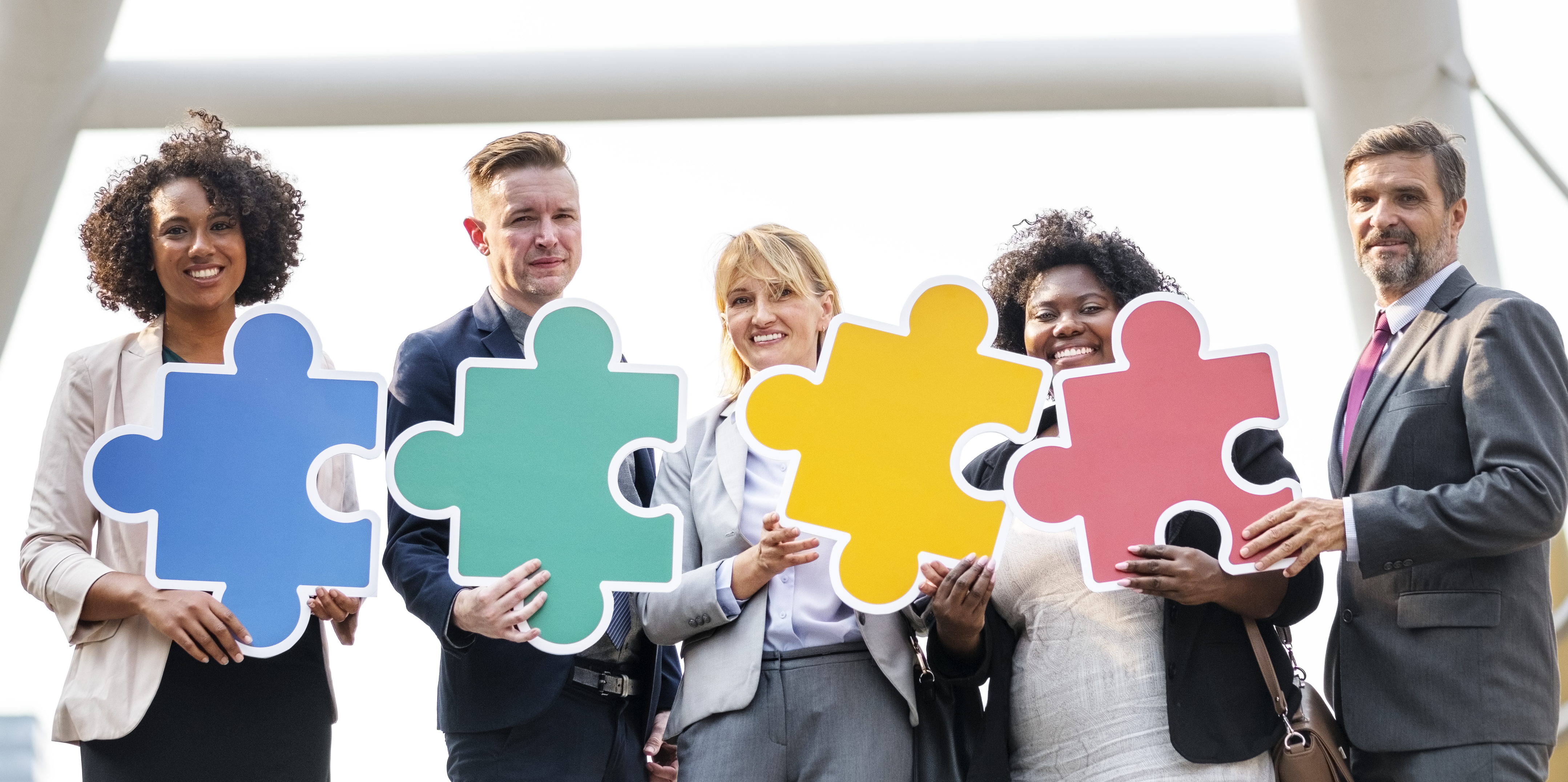 business people connected by puzzle pieces