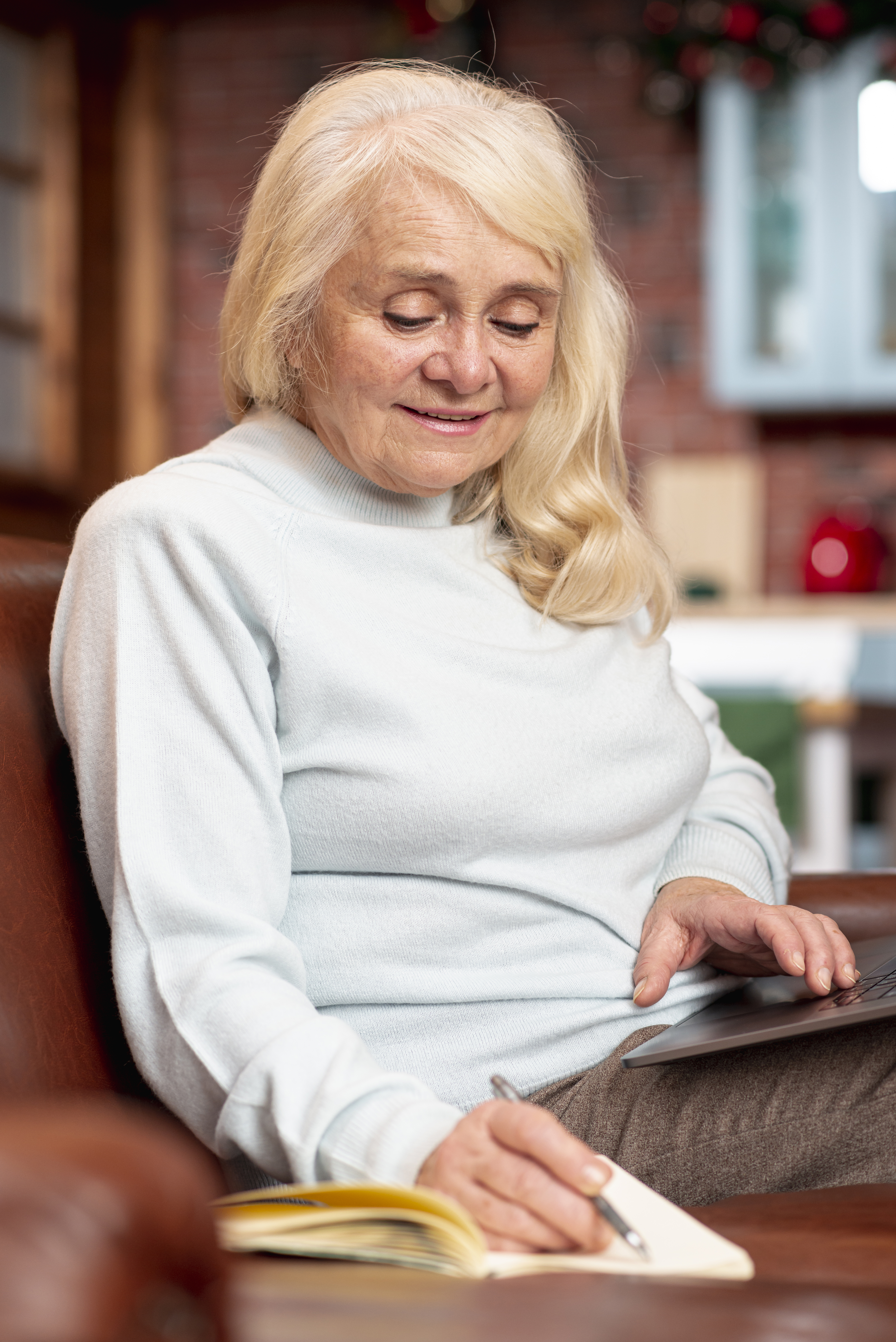 high angle elder woman taking notes